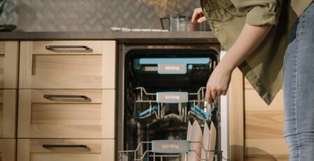 Woman loading dishes into a dishwasher.