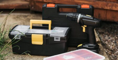 Cordless drill and toolboxes outdoor.