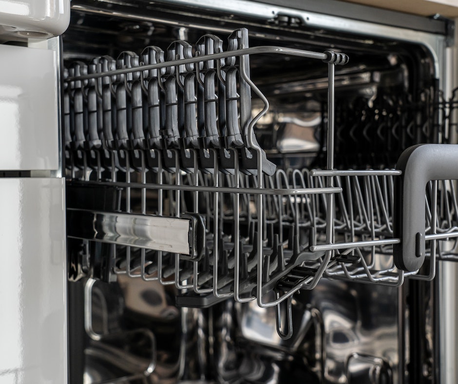 Empty dishwasher interior with racks.